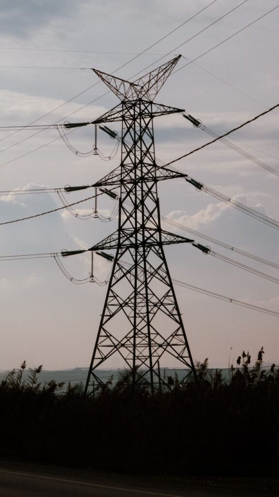 high voltage power lines against sky